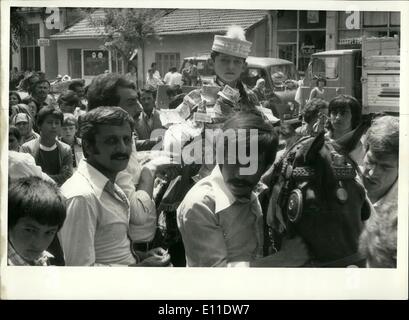 Sep. 09, 1977 - The following two pictures are from the festivities of a traditional circumcision ceremony of a young lad in Eskisehir, in central Turkey. Turks say a boy can become a man only after he has undergone to operation. The festivites require (as seen from the picture) the newly circumcised lad to parade through the streets on horseback, clad in a white gown and a cap, while family members, neighbours and friends attach paper money on him as gifts. Stock Photo