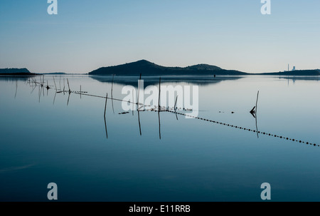 Fishing nets in the Etang de Bages with Port La Nouvelle in the background in the Languedoc Stock Photo