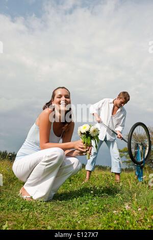 Aug. 28, 2009 - Aug. 28, 2009 - Romantic young couple with old bike in spring nature on sunny day Stock Photo
