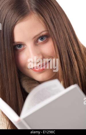 Oct. 29, 2009 - Oct. 29, 2009 - Portrait of young happy woman with book wearing turtleneck on white background Ã‚ Stock Photo