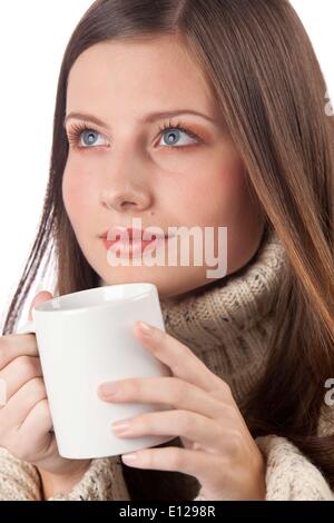 Oct. 29, 2009 - Oct. 29, 2009 - Winter portrait of happy woman holding cup of coffee wearing turtleneck on white Stock Photo