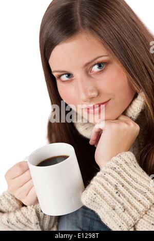 Oct. 29, 2009 - Oct. 29, 2009 - Winter portrait of happy woman holding cup of coffee wearing turtleneck on white : Stock Photo