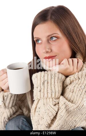 Oct. 29, 2009 - Oct. 29, 2009 - Winter portrait of happy woman holding cup of coffee wearing turtleneck on white Stock Photo