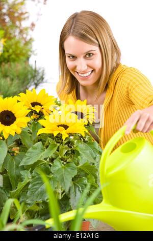 May 03, 2010 - May 3, 2010 - Gardening - woman pouring flowers with watering can Stock Photo