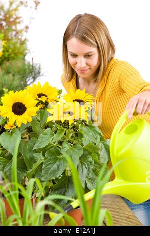 May 03, 2010 - May 3, 2010 - Gardening - woman pouring flowers with watering can Stock Photo