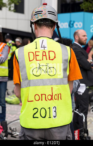London, UK. 21st May, 2014. A mass 'Cycle Die-In' takes place at Elephant & Castle, in memory of the 47 year-old Cyclist killed in HGV collision on Tuesday, 13 May 2014. Cyclists protest to urge Southwark Council and TfL to install emergency protected by-passes at dangerous junctions such as the Elephant, drawing with chalk the protected cycle-lane that they ask to be installed. Credit:  Cecilia Colussi/Alamy Live News Stock Photo