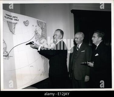 Feb. 24, 2012 - Cleo F. Craig, President, American Tel. & Tel. Co., demonstrate with sample section of route of first intercontinental undersea telephone cable,on which work is now starting. Looking on are H.T. Killingsworth, A.T. & T.. Vice President in charge of Long Lines (center) and W.G.. Thompson, President of Eastern Tel. &Tel. Co., and A.T. &T. subsidiary that will operate new facilities passing through Canada. Stock Photo