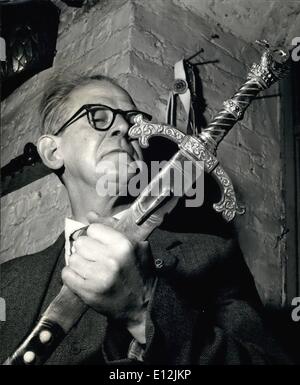 Feb. 24, 2012 - Armourer to the Royal Opera House. Mr. Cyril Brasher examines the Lohengrin sword, showing the swan hilt. The armourer knows exactly what arms are required for any production, and as the collection is brought more and more in order and catalogued, a greater degree of historical accuracy is being achieved. Stock Photo