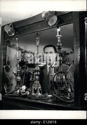 Feb. 24, 2012 - The Pipe Collector. Mr. Barton in his pipe bar with three hookahs. Left: encased in silver, from Persia, dated 1800; centre: hookah, dated 1950, with blue glass bowl in gold, right: Nargileh, from India, meaning coconut. Stock Photo