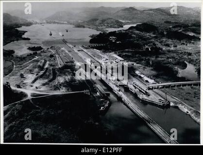 Feb. 24, 2012 - Panama Canal Zone: The locks on the Pacific side of the Panama Canal are divided into two sets. The larger of the two sets, Miraflores Locks, shown in the foreground of this aerial photo lowers a ship 54 feet in two steps. Across the small lake is the one step locks at Pedro Miguel where a ship enters or leaves Gaillard Cut, the eight mile excavation across the Continental Divide. Two small ships being handled as one ship in the 1,000 foot long lock chambers presents a rather unusual sight. Stock Photo