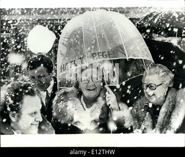 Feb. 24, 2012 - laughing in the snow.: Queen Juliana of the Netherlands opened a Psychiatric center at Oegstgeest, a village near the Haigh. Photo shows Queen Juliana seen walking in a snowstorm outside the center with ''Fine Rain' printed on the umbrella. Stock Photo