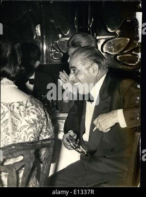 Feb. 26, 2012 - Onassis happy and smiling. OPS: The famous Greek ship owner Aristotle Onassis pictured in a happy mood during the gala dinner held at Maxim's last night. The occasion was the Paris premiere of Anthony Quinn's new film Zorba the Greek . Next to Onassis with back to the camera is Maria la Callas. Stock Photo