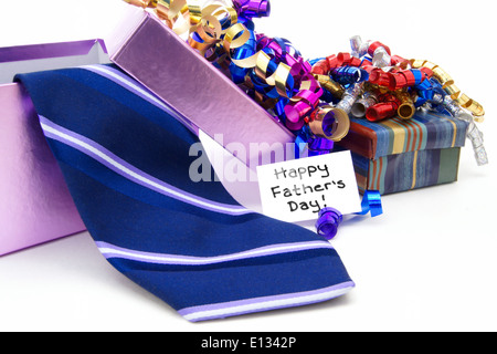 Happy Fathers Day tag with gift boxes and tie over white Stock Photo