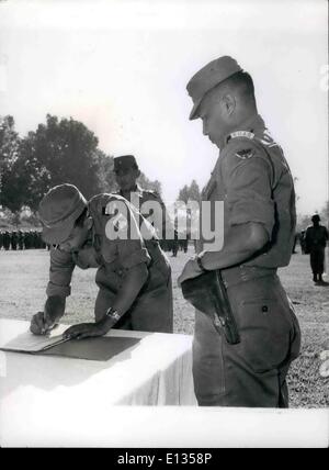 Feb. 28, 2012 - Investing a new military commander in Sumatra. Indonesia Chief of Staff, Gen. Nasution, visiting Central Sumatra for the first time since before the civil war, watches as the new military commander, Lt. Col. Pranoto signs himself in as new commander of the area. Stock Photo