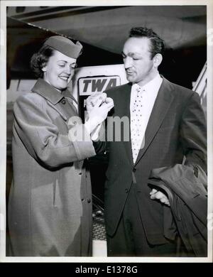 Feb. 29, 2012 - Idlewild Airport, N.Y. Nov. 5 Bosing's Middleweight Champion Carmen Basilio Impresses TWA Hostess Luayine Ohnstad with a huge fist on his arrival here today via TWA from Los Angeles. He attended the opening of IRV Noren's bowling alley in Pasadena last weekend. The former Yankee outfielder, Now with the cardinals, and carmin, are old friends. Stock Photo