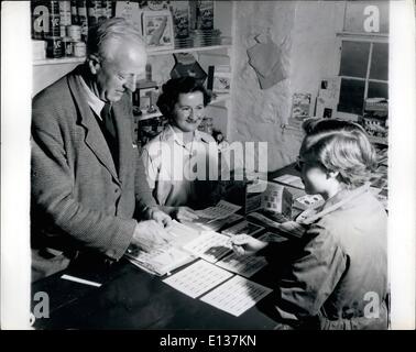 Feb. 29, 2012 - Lundy island: in a corner of the Marisco tavern is the island's store and Mr.F.w.Gade, the island agent, helps Mary Ogilvy, wife of the farm bailiff to serve customers. Spread out on the counter are the famous puffin postage stamps used for incoming and outgoing mail and first used in 1929. Stock Photo