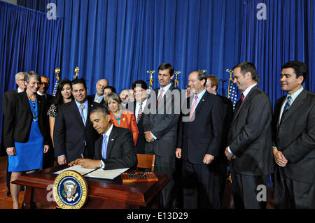 US President Barack Obama surrounded by members of Congress and officials signs a proclamation designating the Organ Mountains-Desert Peaks area of New Mexico a national monument May 21, 2014 in Washington, DC. Stock Photo