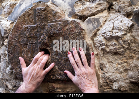 Women's hands at the 8th Station of the Cross, Via Dolorosa, Jerusalem, Holy Land Stock Photo