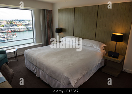 Sydney Australia,Sussex Street,Four Points by Sheraton,hotel,guest room,interior inside,king size bed,window view,Darling Harbour,harbor,Cockle Bay,AU Stock Photo