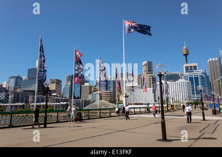 Sydney Australia,Darling Harbour,harbor,Pyrmont Bridge,walking,Cockle Bay,skyscrapers,city skyline,flag,Sydney Tower,AU140311040 Stock Photo