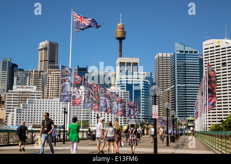 Sydney Australia,Darling Harbour,harbor,Pyrmont Bridge,walking,Cockle Bay,skyscrapers,city skyline,flag,Sydney Tower,AU140311045 Stock Photo