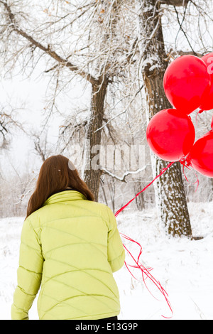 Teenager girl with red balloons walking in the park Stock Photo - Alamy