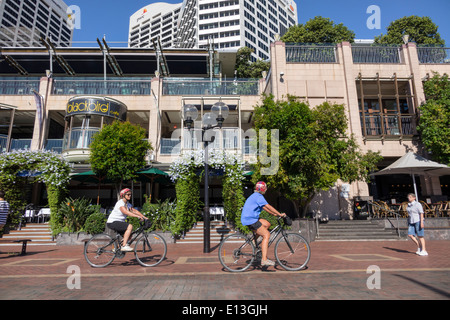 Sydney Australia,Darling Harbour,harbor,Cockle Bay Promenade,Wharf,woman female women,bicycle,bicycling,riding,biking,rider,biking,riding,AU140311091 Stock Photo