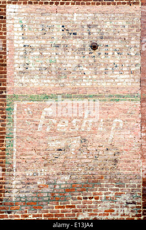 Old faded advertisement painted on the side of a brick building in Elkton, Virginia, USA. Stock Photo