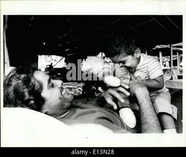 Mar. 02, 2012 - A Cuban refugee plays with his son as they lay on the cot assigned to them at the tent city in the Fort Walton Beach fairgrounds. Stock Photo