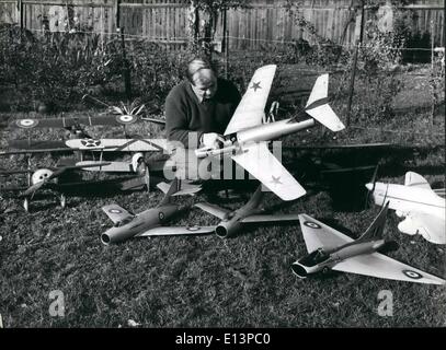 Mar. 22, 2012 - He Has His Own Private Air Force. Mr. Edward Norman in the garden of his Banstead home with some of the 60 aircraft he has made in the last six years. All can fly. They represent all phases through which fighter design has passed since the first world war. In his hands in this picture is a model of the famous Russian MIG 15, perfect in every detail. Stock Photo