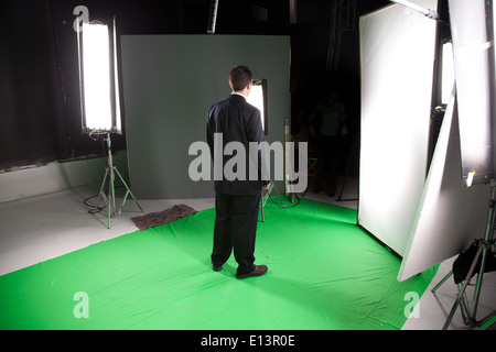 Male fashion model standing in a film studio Stock Photo