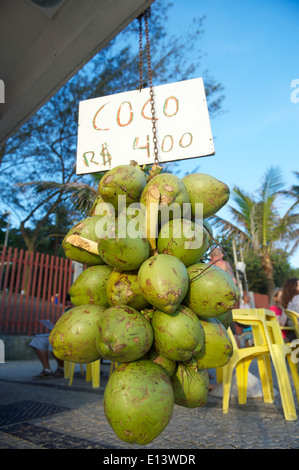 Bunch of fresh green Brazilian coco verde coconuts hanging at a kiosk on Ipanema Beach Rio de Janeiro Brazil Stock Photo