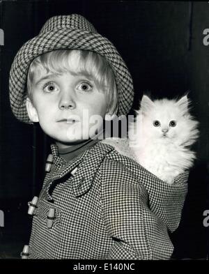 Mar. 31, 2012 - The national cat club championship show at Olympia : Photo shows young Christoper Martyn, age four, of highgate, London. finds a new way of transportation as he arrives at Olympia with a perailm kettle, named gallywog, comfortably touched in the hood of his coat today. Stock Photo