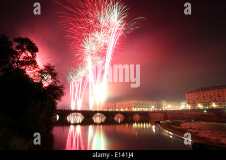 Fireworks show over river Po in Torino during Saint John's celebrations. On the left bridge Vittorio Emanuele I. Stock Photo