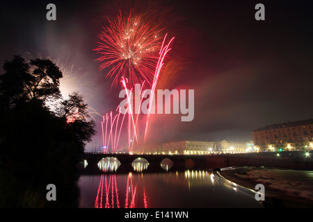 Fireworks over river Po in Torino during Saint John's celebrations. On the left bridge Vittorio Emanuele I. Stock Photo
