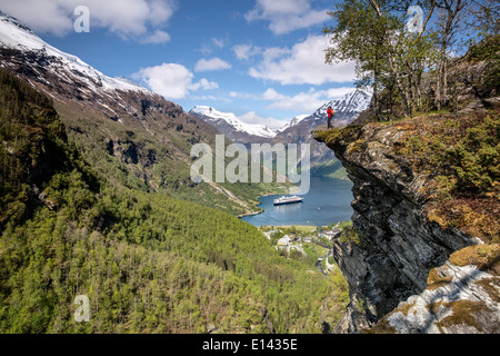 Norway, Geiranger, Geiranger fjord. View on cruise ship MS Rotterdam of Holland America line. Photographer Marjolijn van Steeden taking picture. Stock Photo