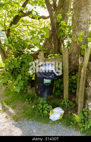 Overflowing rubbish bin in beautiful Lake District, Buttermere, countryside. Stock Photo