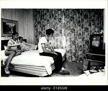 Apr. 04, 2012 - An 18 year old Cuban refugee, his wife, and her mother sit in a hotel room in Miami as they watch a Spanish new Stock Photo