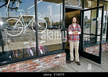 Caucasian man smiling in bicycle shop