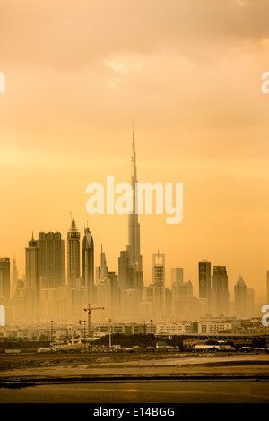 United Arab Emirates, Dubai, Financial city center skyline with Burj Khalifa, the highest building in the world. Sunset Stock Photo