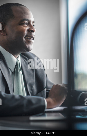 African American businessman working at desk Stock Photo