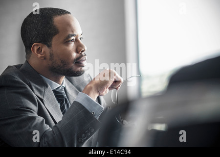Businessman sitting at desk Stock Photo