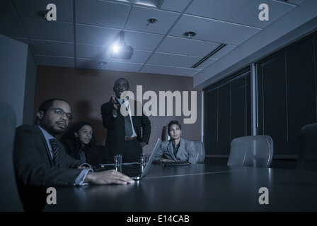 Business people watching presentation in meeting Stock Photo