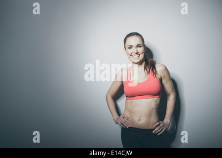 Portrait of smiling Caucasian woman in sports-bra Stock Photo
