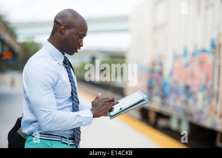 African American businessman waiting for train Stock Photo