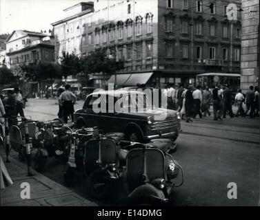 Apr. 18, 2012 - Trieste: A new day dawn: Early morning rush hour in the busy streets. Motor scooters are popular with the businessman and woman. Stock Photo