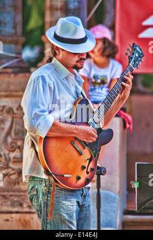 portrait of a young man standing playing the electric guitarist Stock Photo