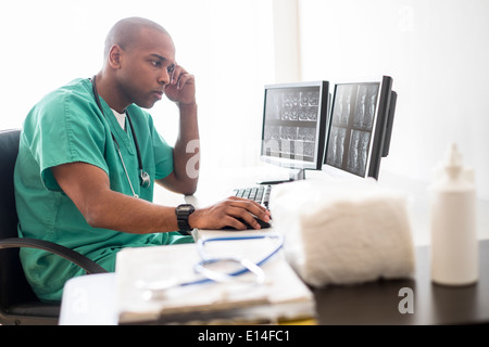 Black doctor working on computer in office Stock Photo