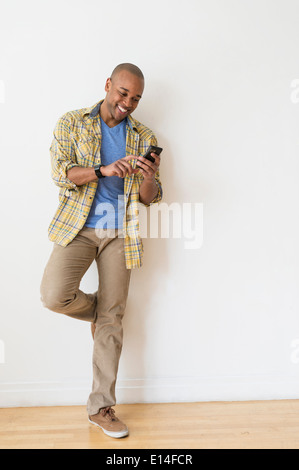 Black man using cell phone Stock Photo
