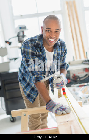 Black carpenter working in shop Stock Photo